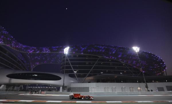 Ferrari Formula One driver Fernando Alonso of Spain passes the Yas Hotel during the qualifying session of the Abu Dhabi F1