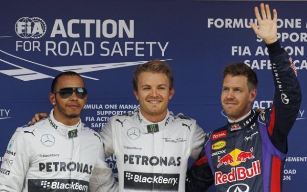 Mercedes Formula One driver Nico Rosberg (C) of Germany celebrates his pole position next to team mate Lewis Hamilton of Britain (L) and Red Bull Formula One driver Sebastian Vettel (R) of Germany after the qualifying session at the Spanish F1 Grand Prix at the Circuit de Catalunya in Montmelo, near Barcelona May 11, 2013. Rosberg handed Mercedes their third pole position in succession on Saturday with team mate Lewis Hamilton sealing a front row... 